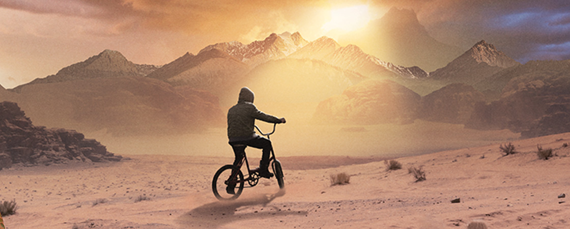 Image of person on bike looking at mountains in front of them 