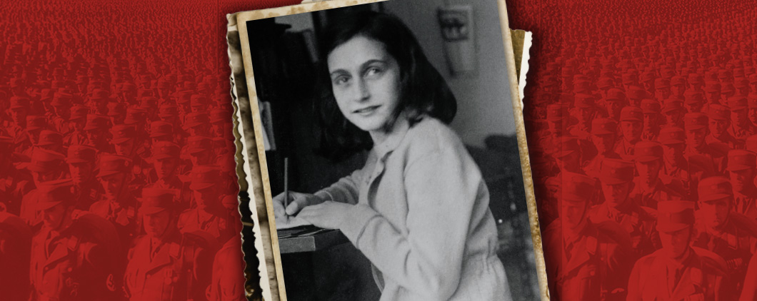 Black & white photo of Anne Frank writing at a desk