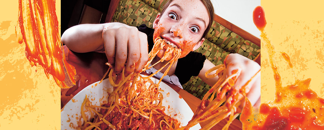 Image of a kid messily eating spaghetti with their hands