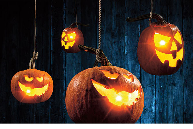 Four hanging jack-o&apos;-lanterns